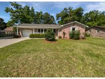 Charming brick home featuring a well-manicured lawn and a attached garage, creating a welcoming curb appeal at 102 Rebellion Rd, Summerville, SC 29483
