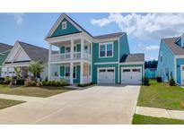 Charming two-story home boasts a welcoming double porch and attached two-car garage at 1238 Homecoming Blvd Blvd, Ravenel, SC 29470