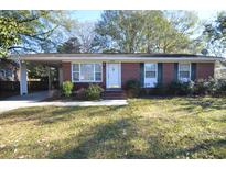 Charming brick home with a manicured lawn, covered carport, and inviting front entrance at 1340 Ashley Hall Rd, Charleston, SC 29407