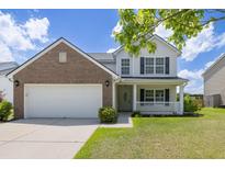 Charming two-story home with a brick facade, a well-manicured lawn, and a welcoming front porch at 167 Decatur Dr, Summerville, SC 29486