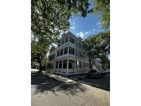 Charming multi-story home with a grand double veranda and classic architectural details surrounded by lush greenery at 41 Legare St # C, Charleston, SC 29401