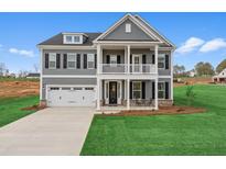 Beautiful two-story home with a well-manicured lawn, attached two car garage and welcoming covered porch at 4314 Grange Cir, Summerville, SC 29486