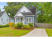 Charming blue two-story home with white trim, a cozy front porch, and a well-manicured front yard at 4524 Orr St, North Charleston, SC 29405