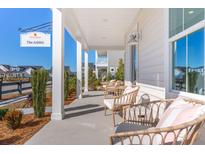 Inviting front porch featuring comfortable seating, perfect for relaxing and enjoying the neighborhood view at 782 Clay Field Trl, Summerville, SC 29485
