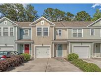 Charming townhomes featuring colorful exteriors, attached garages and well-maintained landscaping enhance curb appeal at 9418 Sweep Dr, Summerville, SC 29485