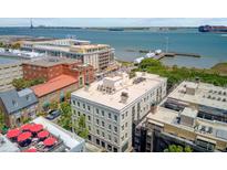 An aerial view showcasing a Charleston, SC neighborhood with waterfront and rooftop features at 1 Vendue Range # I, Charleston, SC 29401