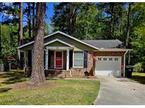 Charming brick home with an attached garage and a well-maintained lawn at 103 Bruce Ct, Summerville, SC 29486