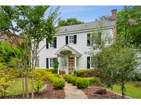 Charming two-story home with white siding, black shutters, landscaped yard, and a brick pathway to the front door at 2158 Westrivers Rd, Charleston, SC 29412