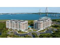 Stunning aerial view of waterfront condos, bridge, and manicured landscaping at 222 S Plaza Ct, Mount Pleasant, SC 29464