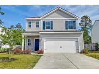 Charming two-story home with gray siding, blue shutters, and a two-car garage under a bright blue sky at 239 Parkwood Vista Way, Summerville, SC 29486