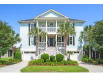 Inviting two-story home features dual garages, a double porch, palm trees, and manicured landscaping at 3101 S Shore Dr, Charleston, SC 29407