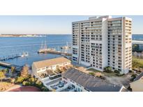 Scenic high-rise building overlooking the harbor with multiple residences and marina access with docked sailboats at 330 Concord St # 2F, Charleston, SC 29401