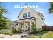 Charming two-story home with a quaint front porch and well-manicured landscaping at 383 Oak Park St, Summerville, SC 29486