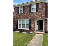 Charming two-story brick home featuring a well-manicured lawn and welcoming front entrance at 4324 Purdue Dr, North Charleston, SC 29418