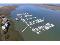 An aerial view of a boat harbor with boats docked next to waterfront homes and beautiful water views at 67 W 10Th St # D-26, Folly Beach, SC 29439