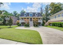 Charming two-story home with a spacious driveway, lush lawn and appealing traditional design at 8657 Refuge Point Circle Cir, Charleston, SC 29420