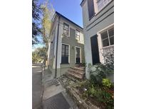 Charming two-story home featuring a well-maintained exterior and brick stairs leading to the entrance at 9 West St # 1, Charleston, SC 29401