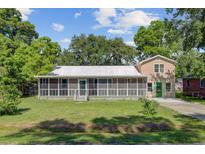 Charming single-story home with a large screened-in porch and landscaped front yard at 113 Harvey Ave, Goose Creek, SC 29445