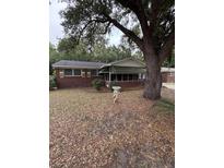 Charming one story brick home featuring a screened porch and mature trees at 1130 Yeamans Hall Rd, Hanahan, SC 29410