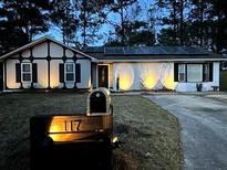 Charming home with black and white exterior and solar panels on the roof at 117 Fripp Ln, Summerville, SC 29483