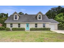 Charming one-story home featuring dormer windows and a vibrant blue front door at 123 Wheeler Rd, Summerville, SC 29486
