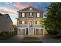 Charming two-story home with a front porch, garage, and well-maintained landscaping at 1505 Fort Palmetto Cir, Mount Pleasant, SC 29466