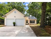 Charming home featuring a two-car garage, inviting entrance, and well-maintained landscaping at 2021 Arundel Pl, Mount Pleasant, SC 29464