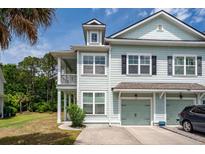 Charming townhome with pale siding, two stories, open porch, and attached one-car garage at 2119 Oyster Reef Lane Ln, Mount Pleasant, SC 29466