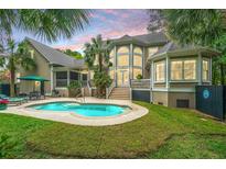 Private backyard pool featuring lush landscaping and architectural details, perfect for relaxation at 225 River Oak Dr, Mount Pleasant, SC 29464