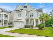 Charming two-story home with manicured lawn, a covered porch, and an attached two-car garage at 2962 Clearwater Dr, Mount Pleasant, SC 29466