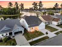 Stunning aerial view of lakeside homes with well-manicured lawns and a picturesque community at 327 Tupelo Lake Dr, Summerville, SC 29486
