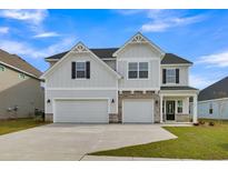 Charming two-story home features a two-car garage and inviting front porch with stylish architectural details at 3307 Sawlog Dr, Summerville, SC 29486