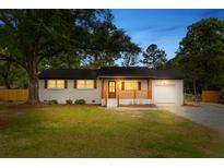 Charming one-story home featuring brick exterior, wooden shutters, and a cozy front porch at 346 Horseshoe Rd, Moncks Corner, SC 29461