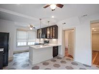 Bright kitchen with white countertops, tile floors, stainless appliances, and dark cabinetry at 35 Society # H, Charleston, SC 29401