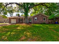 Charming brick home with a well-maintained lawn and mature trees offering plenty of shade at 4327 Bream Rd, North Charleston, SC 29418
