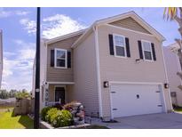 Charming two-story home with neutral siding, black shutters, and a well-maintained front yard at 4916 Paddy Field Way, Ladson, SC 29456