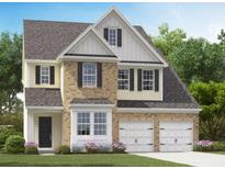 Charming two-story home with a brick and siding exterior, complemented by a well-manicured lawn and a two-car garage at 538 Verdi Dr, Summerville, SC 29486