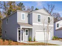 Charming two-story home featuring gray siding, a covered front porch, and an attached one-car garage at 601 Quiet Valley Rd, Summerville, SC 29486