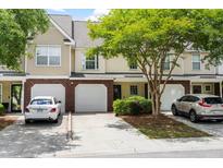 Attractive townhome with a brick facade, attached garage, and well-maintained landscaping at 8676 Grassy Oak Trl, North Charleston, SC 29420