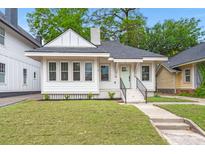 Charming single-story home featuring a well-manicured lawn, a pastel-painted front door, and a cozy front porch at 1014 Alamo St, North Charleston, SC 29405