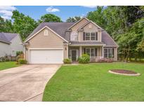Charming two-story home with a well-manicured lawn and attached two-car garage at 113 Ashton Cv, Summerville, SC 29485