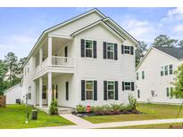 Charming two-story home with a spacious porch and manicured landscaping at 117 Osprey Ridge Ln, Summerville, SC 29483