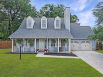 Charming home with a covered porch, dormer windows, and a well-manicured lawn at 1410 Diamond Boulevard, Mount Pleasant, SC 29466