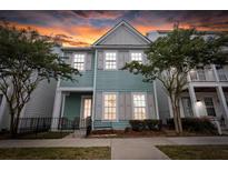 Charming two-story home featuring a quaint front porch and lovely curb appeal with verdant landscaping at 1661 Indy Dr, North Charleston, SC 29405