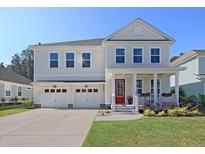 Charming two-story home featuring a red door, well-manicured lawn and a two-car garage at 291 Calm Water Way, Summerville, SC 29486