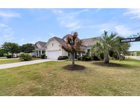 Charming single-story home in Oyster Bay, featuring a well-manicured lawn and mature trees at 318 Oyster Bay Dr, Summerville, SC 29486