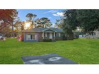 Charming single-story home with blue and brick exterior and lush green lawn at 33 Elliott Ct, Walterboro, SC 29488