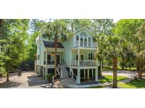 Charming two-story home with landscaped yard and double balconies, perfect for enjoying the coastal breezes at 3738 Station Point Ct, Mount Pleasant, SC 29466