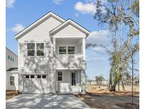 Charming two-story home with a balcony, garage, and well-manicured landscaping at 399 Claret Cup Way, Charleston, SC 29414
