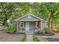 Charming single story home featuring a cozy front porch and a well maintained yard, offering an inviting curb appeal at 4546 Holly St, North Charleston, SC 29405